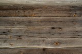 Wooden background of light brown boards, laid horizontally. Wall of an old wooden house, fragment