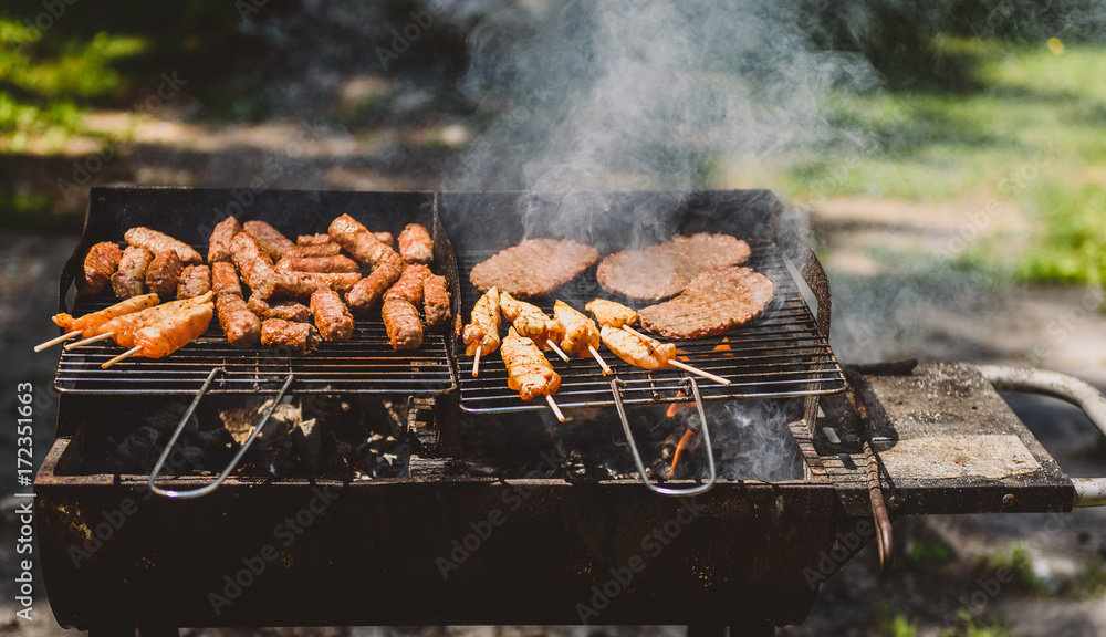Delicious meat on barbecue grill with coal outdoors picnic. Delicious meat on barbecue grill with coal outdoors picnic.