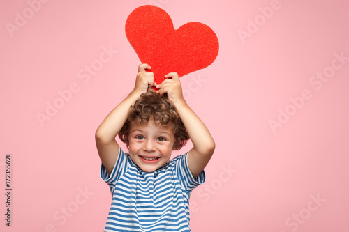 Charming kid posing with heart