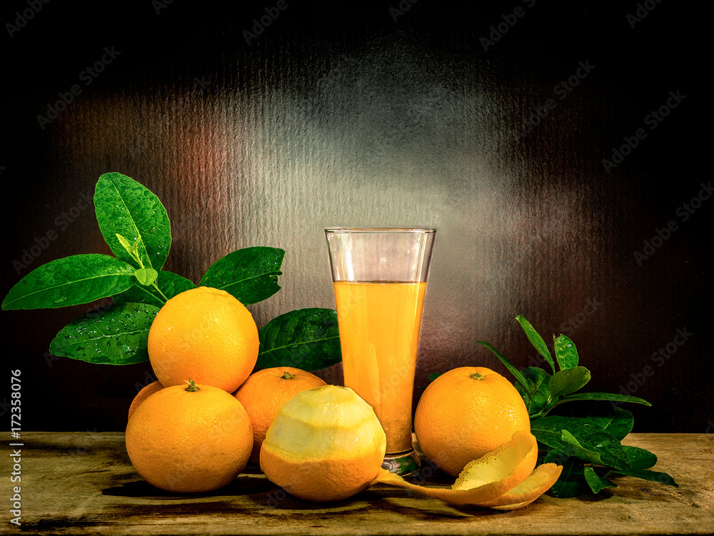 A glass of orange juice with the fresh oranges. A glass of orange juice with the fresh oranges.