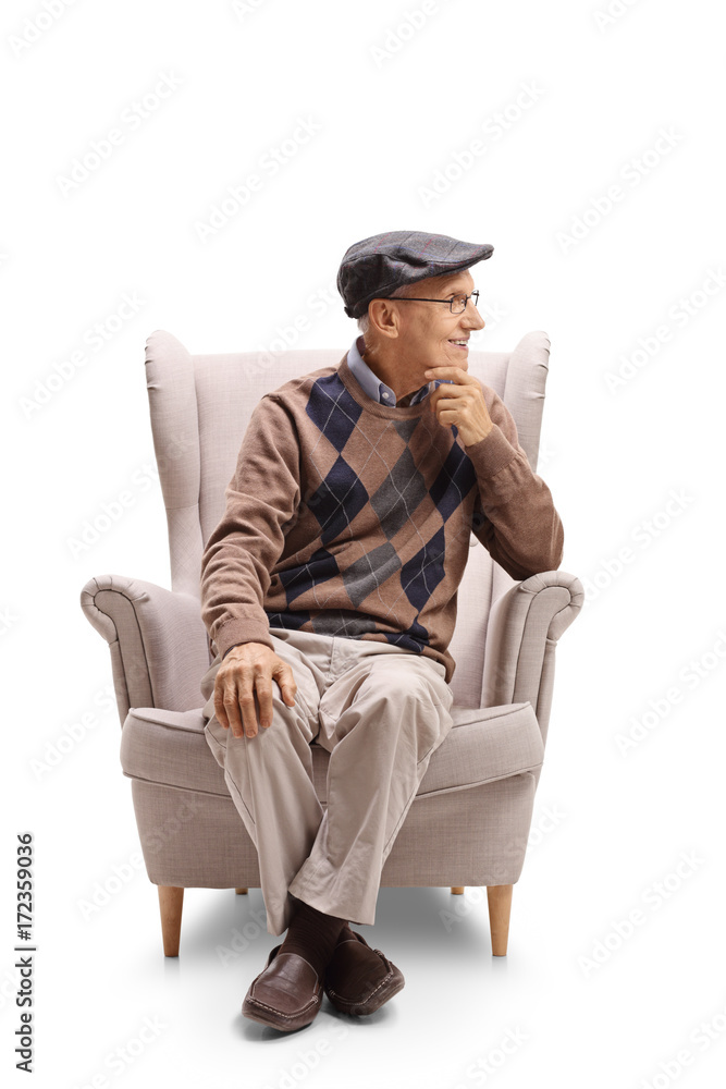 Elderly man sitting in an armchair and looking away