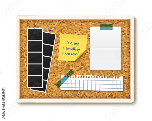 Items pinned to corkboard with wood frame