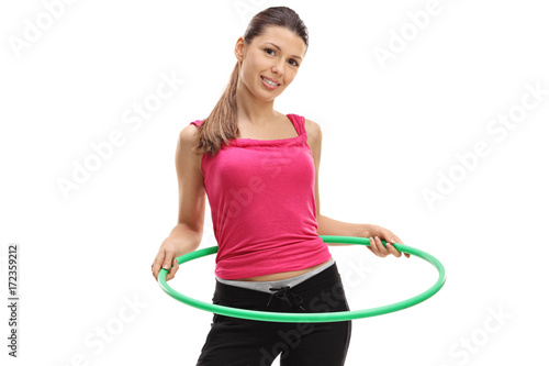 Female athlete exercising with a hula-hoop