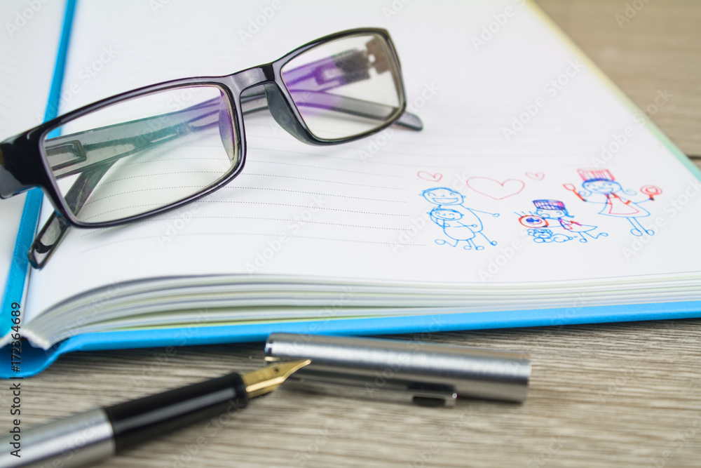 glasses placed on the book,Stripes cartoon family on the book. glasses placed on the book,Stripes cartoon family on the book.