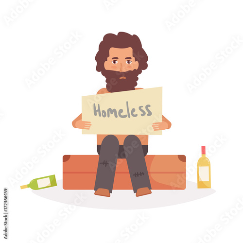 Homeless man sits on a suitcase.