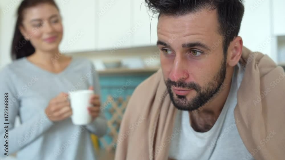 Close up of ill man feeling relief after wife help Close up of ill man feeling relief after wife help