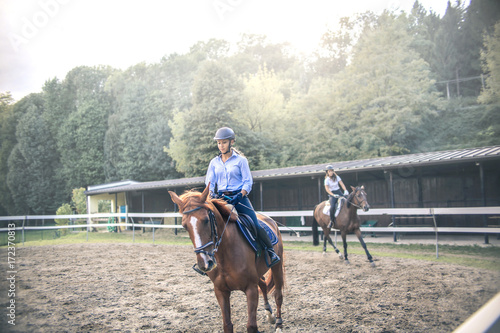Girls riding horses in a competition court