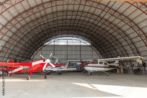 Interior view of airplanes parked in hangar photo