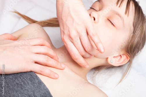 Girl receiving osteopathic treatment of her neck