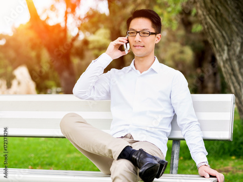 Businessman portrait with mobile phone outdoors