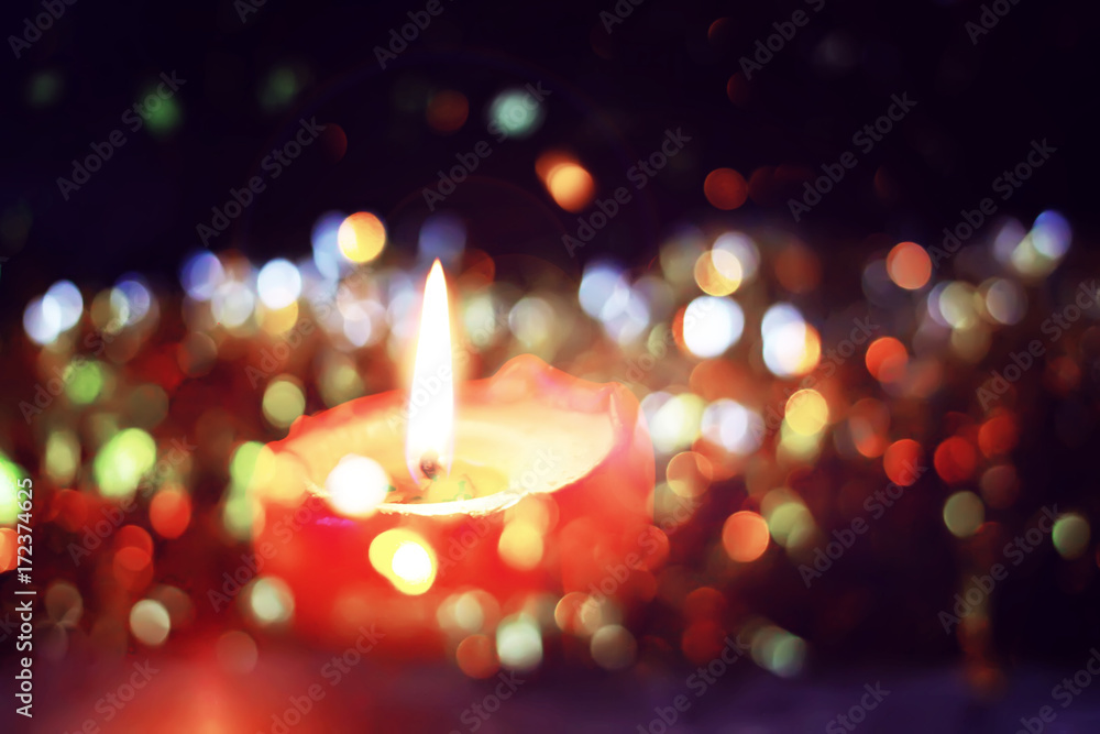 Burning candle on Christmas decoration background. Burning candle on Christmas decoration background.