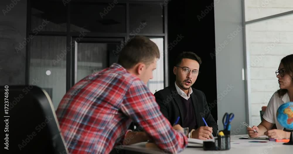 Creative team of a business meeting in a modern starting office, discussing ideas for the development of their business Creative team of a business meeting in a modern starting office, discussing ideas for the development of their business
