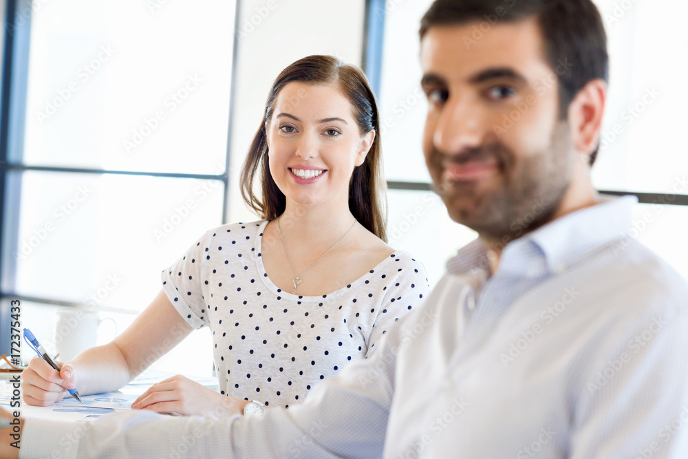 Image of two young business people in office