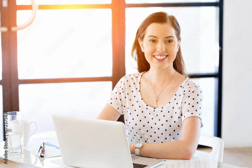 Portrait of businesswoman working at computer in office Portrait of businesswoman working at computer in office