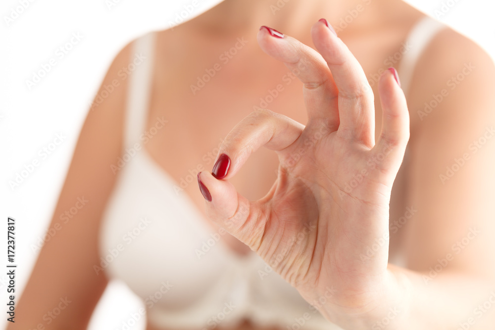 Closeup photo of a beautiful female hands with red nails on white background Closeup photo of a beautiful female hands with red nails on white background