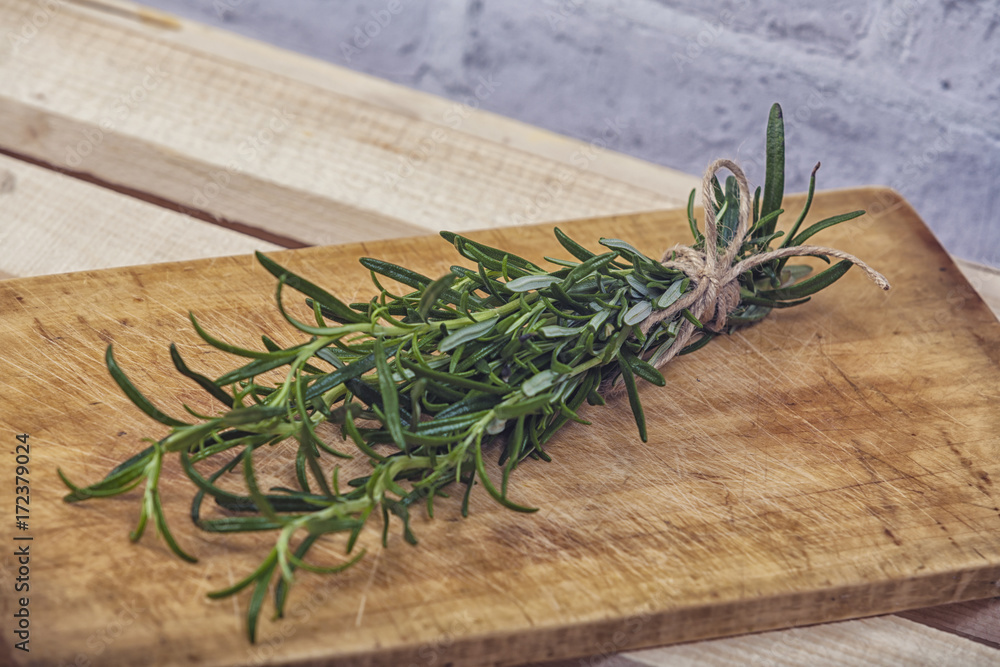 bunch of green scented rosemary on wooden background bunch of green scented rosemary on wooden background