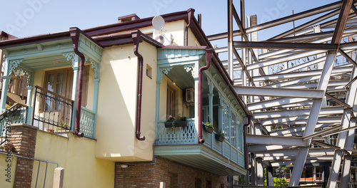 Construction of a modern complex next to residential buildings.