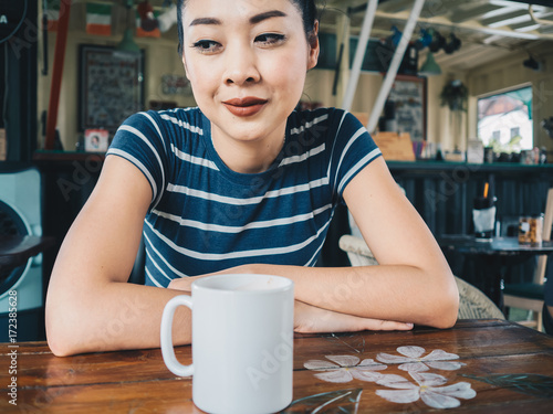 Happy woman drinking coffee in coffee cafe. photo