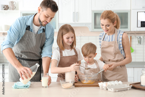 Family cooking in kitchen. ...
