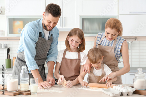 Family cooking in kitchen. ...