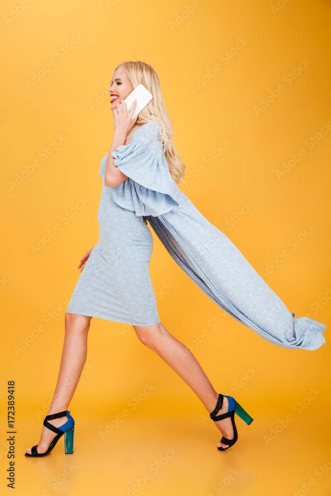 Beautiful young blonde woman talking by phone. Beautiful young blonde woman talking by phone.