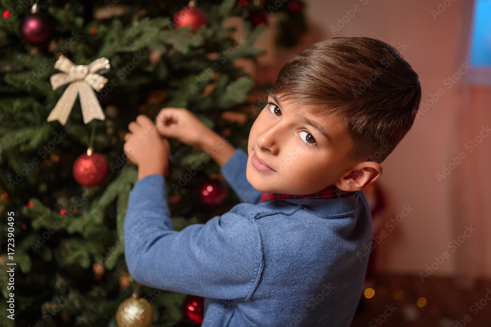 boy decorating christmas tree boy decorating christmas tree