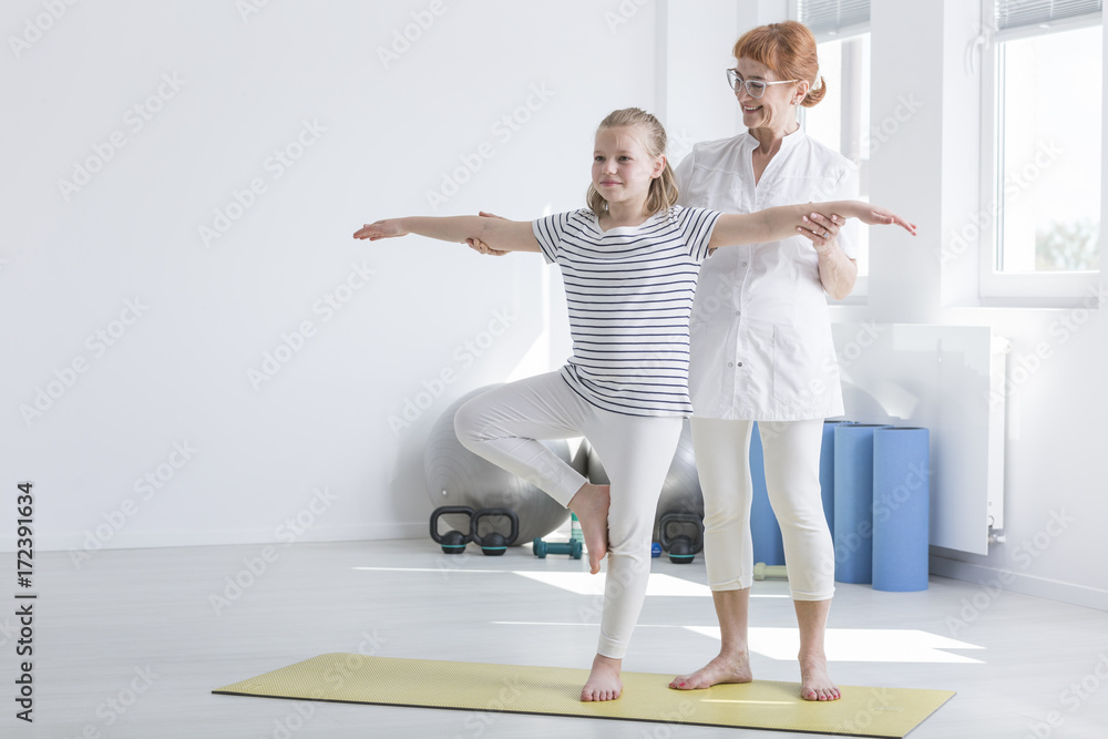 Girl doing exercise improving posture Girl doing exercise improving posture