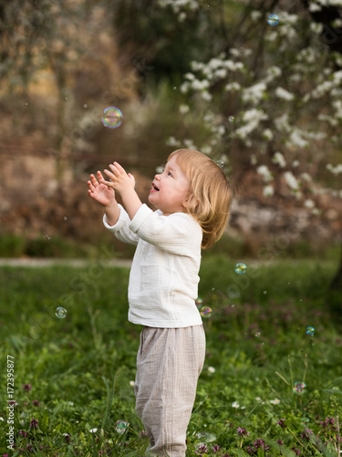 Happy child with soap bubbles