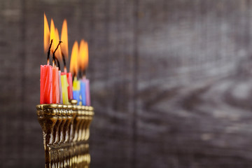 Jewish holiday hannukah symbols - menorah, doughnuts, chockolate coins and wooden dreidels.