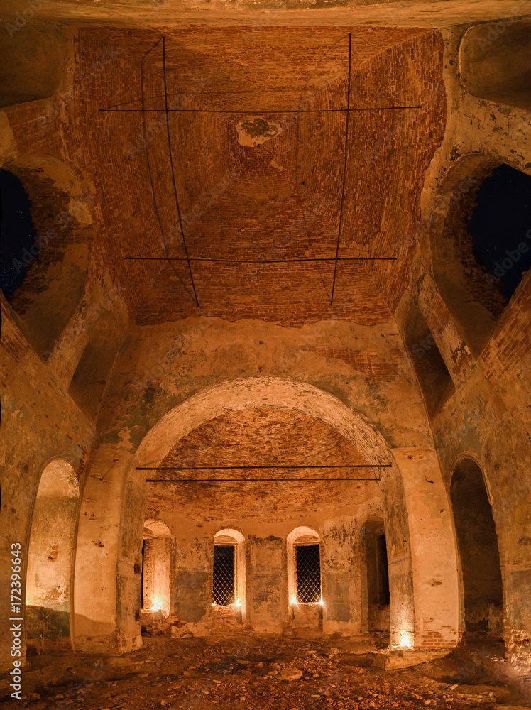 Ruins of old orthodox church lit by candles with starry sky seen in windows Ruins of old orthodox church lit by candles with starry sky seen in windows