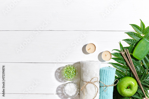 Spa products. Bath salts  soap  candles and towel. Flat lay on white wooden background  top view.
