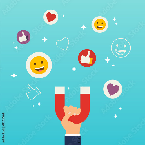 Social media marketing concept. Hand holding magnet attracting likes, hearts and reaction smileys.