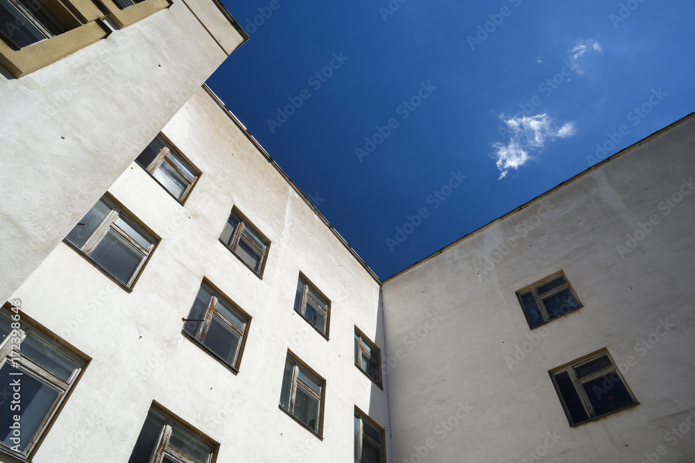 White building with square windows against blue sky