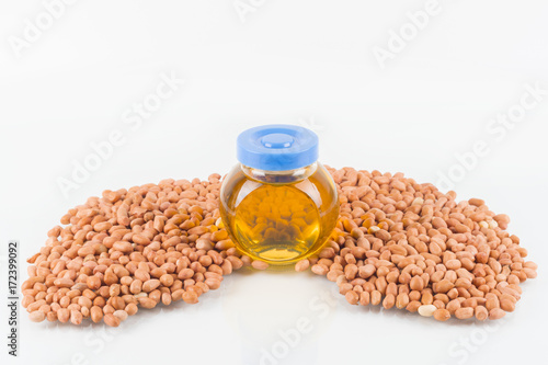 Concept groundnuts isolated white background with Peanuts oil close up and selective focus