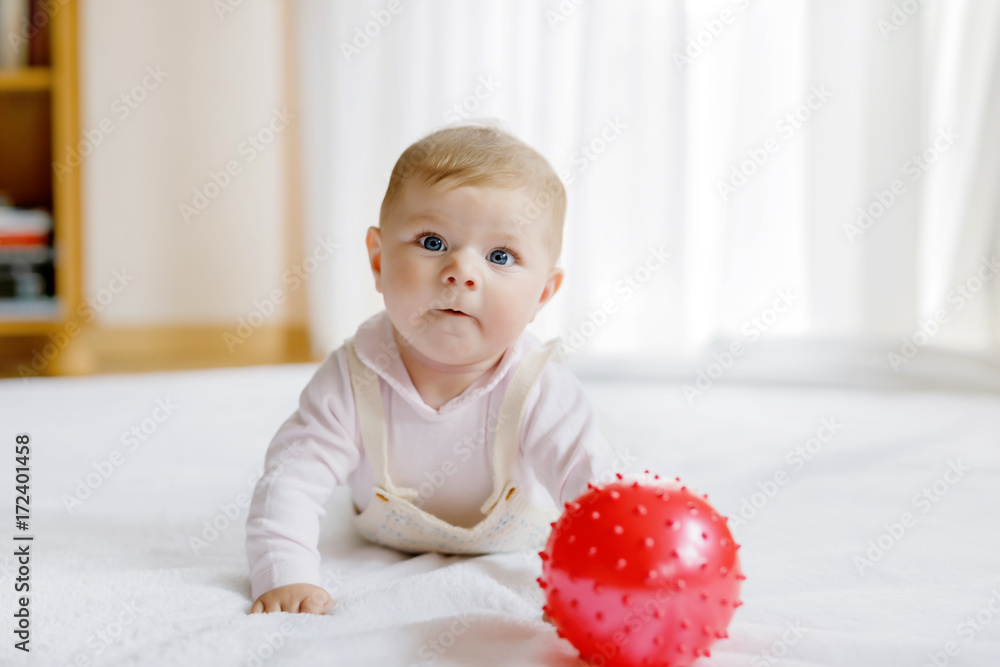 Cute baby playing with red gum ball, crawling, grabbing Cute baby playing with red gum ball, crawling, grabbing