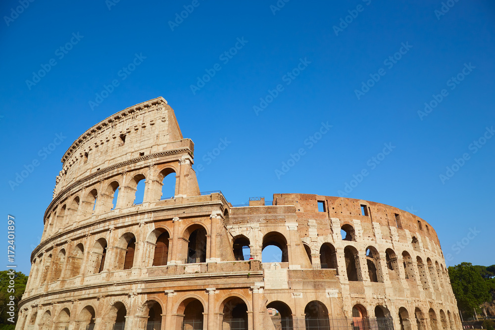Colosseum against the blue sky in Rome, Italy
