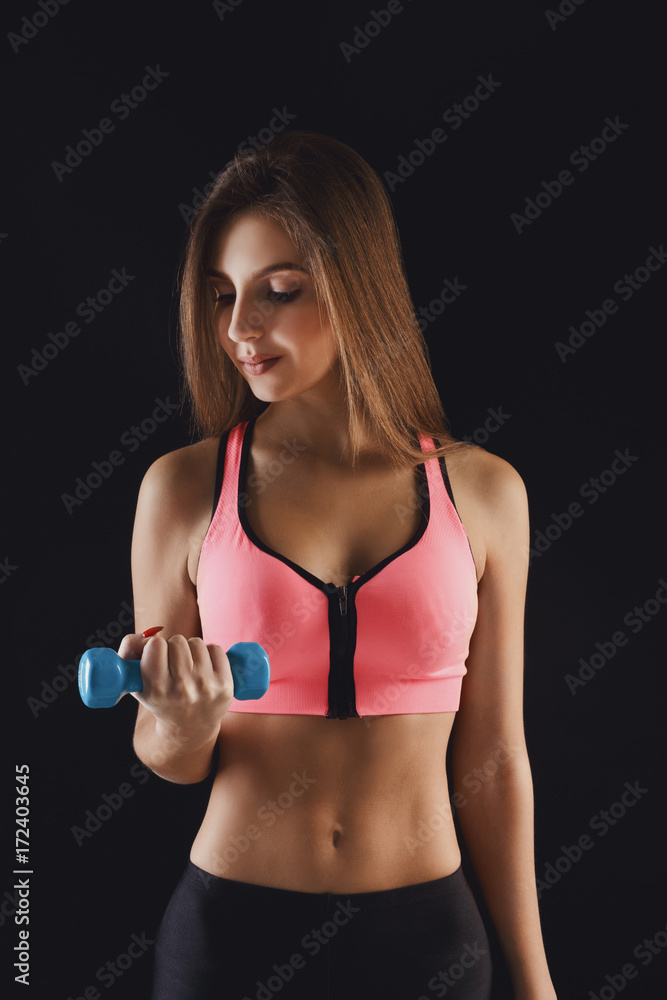 Fitness model woman with dumbbells at studio Fitness model woman with dumbbells at studio