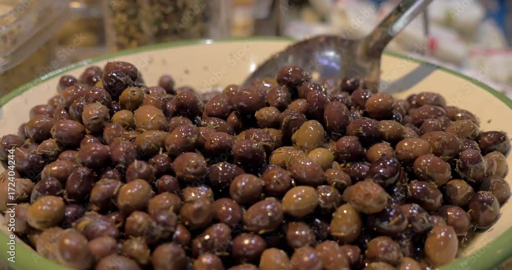 Close-up shot of a big bowl full with marinated olives at food market Close-up shot of a big bowl full with marinated olives at food market