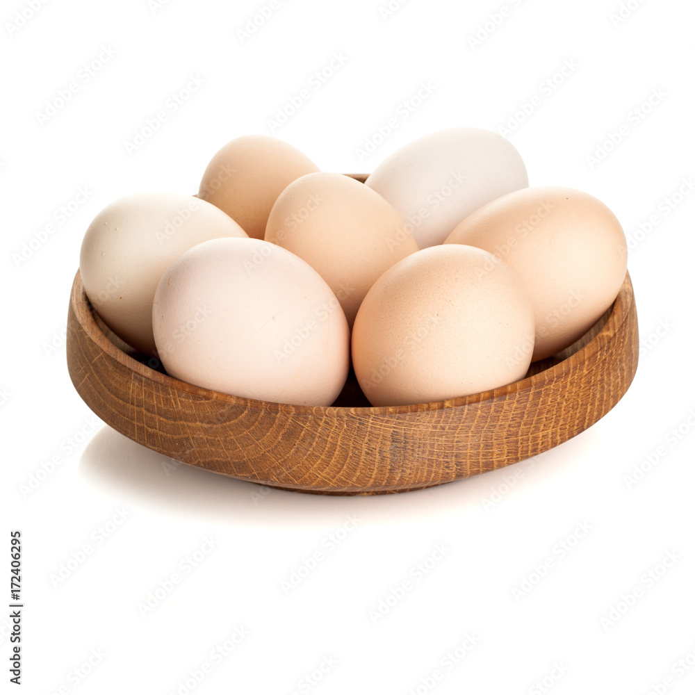 chicken eggs in a wooden plate isolated on white background chicken eggs in a wooden plate isolated on white background