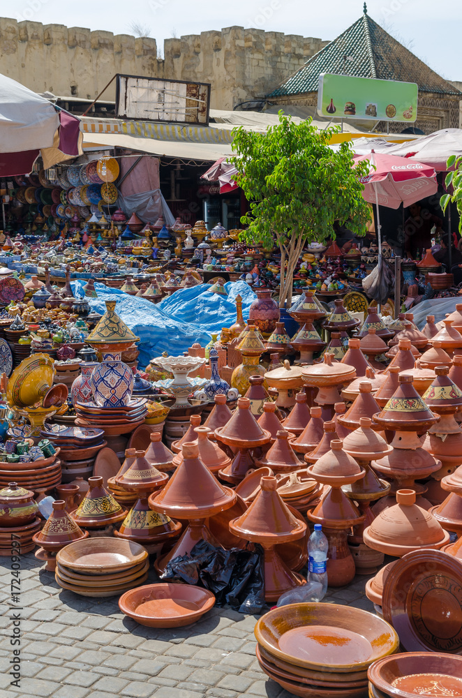 Hundreds of colorful tajine cooking pots stacked on market in soukh of Meknes, Morocco, North Africa