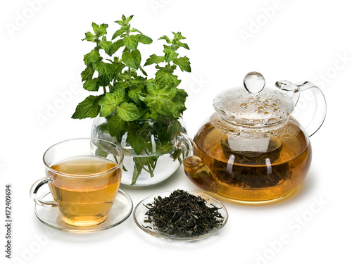 Fresh mint, tea leaves green tea and a drink in ware from glass