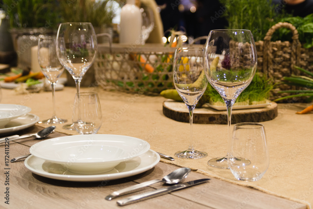 Table setting decor with cutlery, plates and glasses Table setting decor with cutlery, plates and glasses