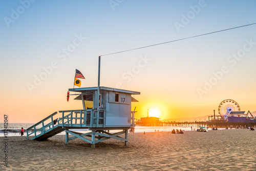 santa monica famous lfeguard tower and pier at background, los angeles