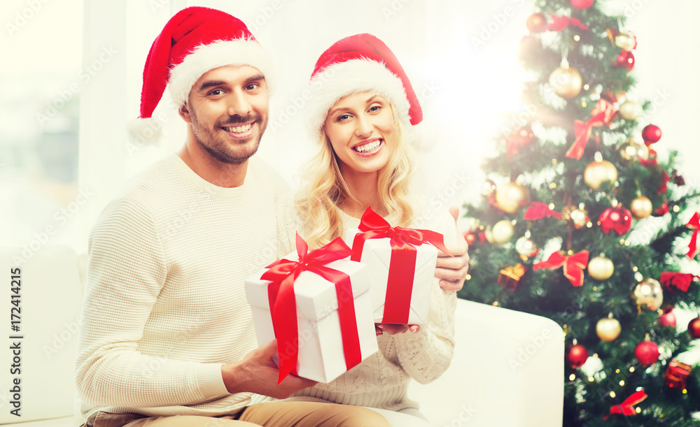 happy couple at home with christmas gift boxes happy couple at home with christmas gift boxes