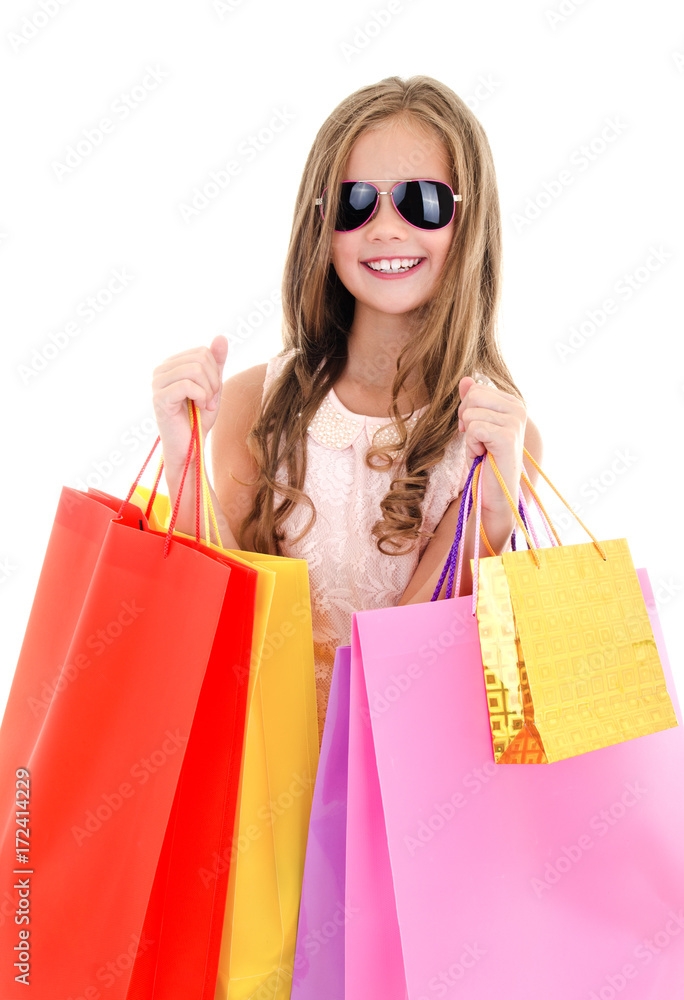 Adorable little girl child in sunglasses holding shopping colorful paper bags Adorable little girl child in sunglasses holding shopping colorful paper bags