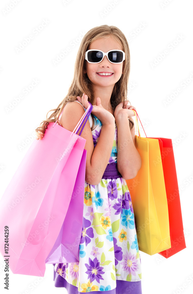 Adorable little girl child in sunglasses holding shopping colorful paper bags Adorable little girl child in sunglasses holding shopping colorful paper bags