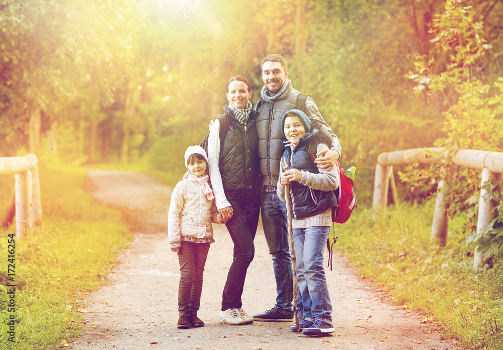 Obraz premium happy family with backpacks hiking