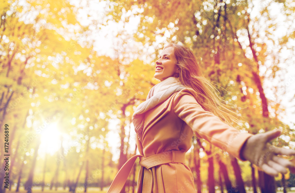 Fototapeta premium beautiful happy young woman walking in autumn park