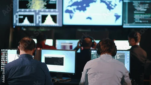 Group of People in Mission Control Center filled with Displays, Celebrating Successful Rocket Launch.