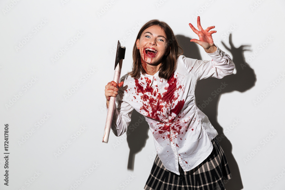 Smiling zombie woman covered in blood stains Stock Photo | Adobe Stock